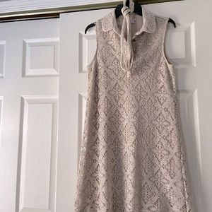 Sleeveless lace dress with attached sheath underneath.